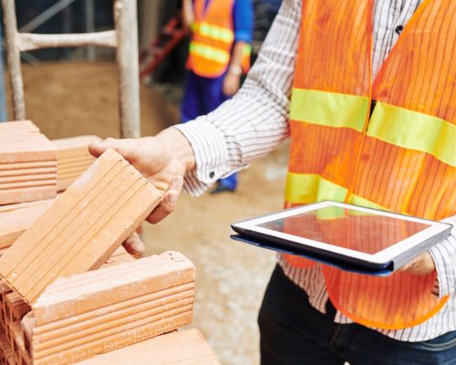 Construction engineer checking building materials